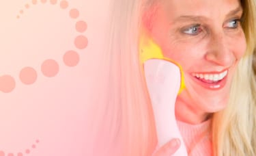 woman using clinical led light therapy on her face while relaxing