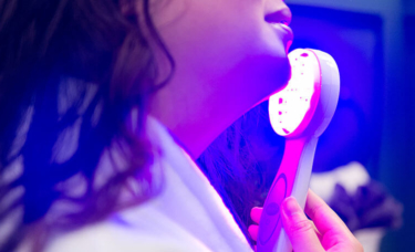 Woman Using Blue Light Acne treatment Device