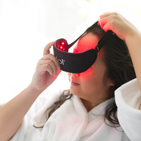 Woman Putting On dpl Eye Mask With Lights On