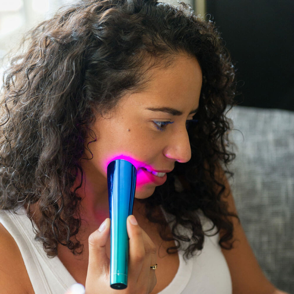 Woman Using Glo Portable Device On Face