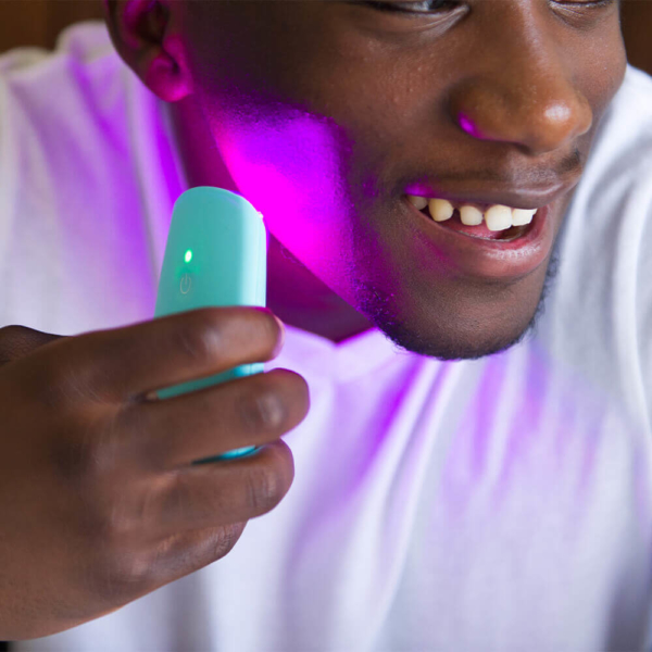 Man Using LED Light Acne Treatment