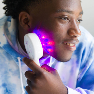 Man Using Clinical LED Light Acne Treatment Device