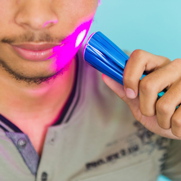 Man Using Glo Portable LED Light Acne Treatment