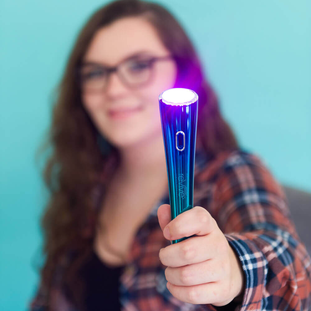 Woman Holding Glo Portable LED Light Acne Treatment Device