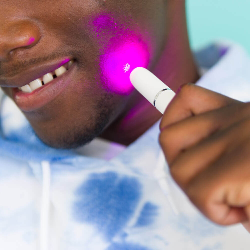 Man Using Purple Light Poof Device
