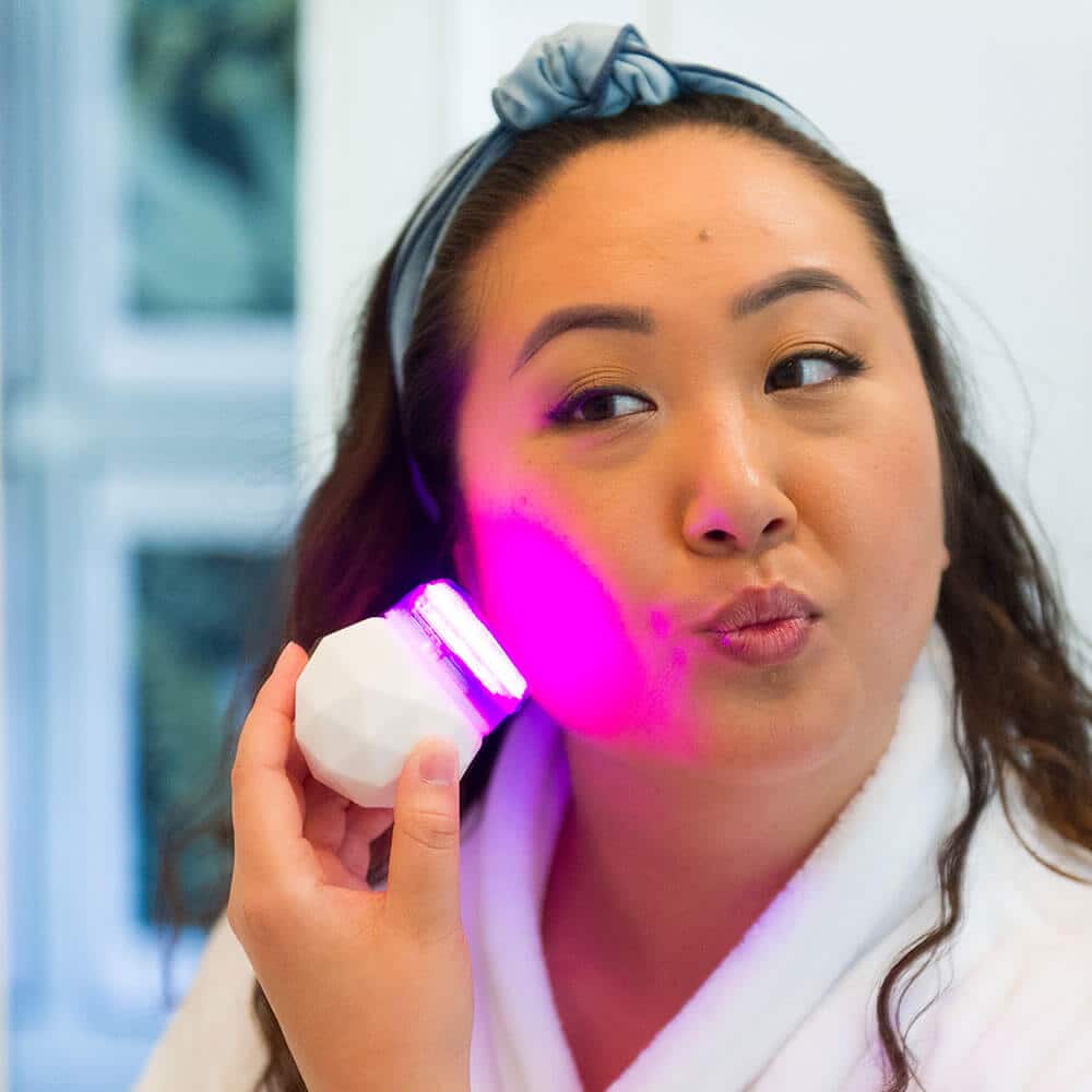 Woman Using Sonique Mini LED Sonic Cleanser Woman Using Sonique Mini LED Sonic Cleanser