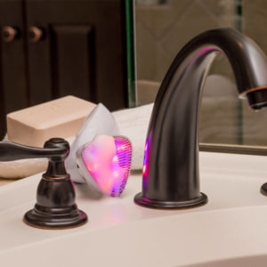 Sonique LED Sonic Cleanser Behind Sink