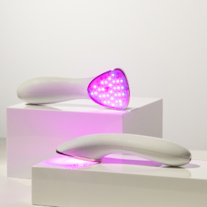 Two Lux Collecton Clinical products have LED lights on; they sit on white acrylic blocks and one's triangular head faces the viewer and the other faces down