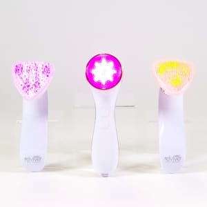 Group of Sonique Sonic Cleansing devices with lights on