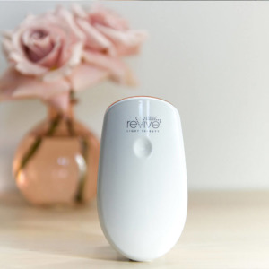Lux Essentials Anti-Aging or Acne device on shelf next to vase