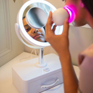 young woman looking into Vio Beauty Mirror