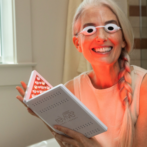 Woman Using the reVive Light Therapy Lux LED Treatment Panel Woman Using the reVive Light Therapy Lux LED Treatment Panel