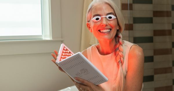 Woman Using the reVive Light Therapy Lux LED Treatment Panel Woman Using the reVive Light Therapy Lux LED Treatment Panel