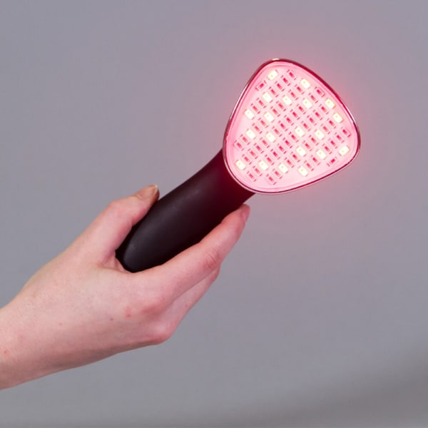 hand holding clinical xl led light therapy for pain relief