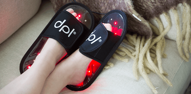 feet up on the couch relaxing with DPL led light therapy slippers for pain relief