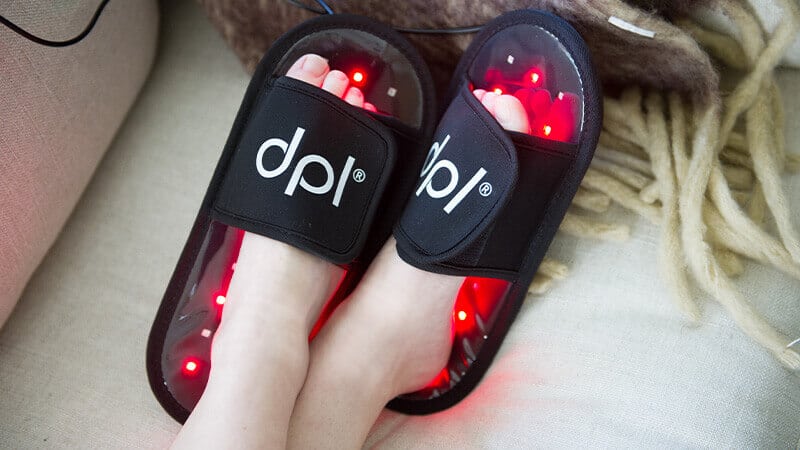 relaxing on couch with feet up in dpl light therapy slippers