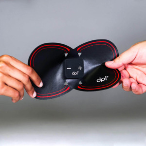 two hands holding TENS back pain device